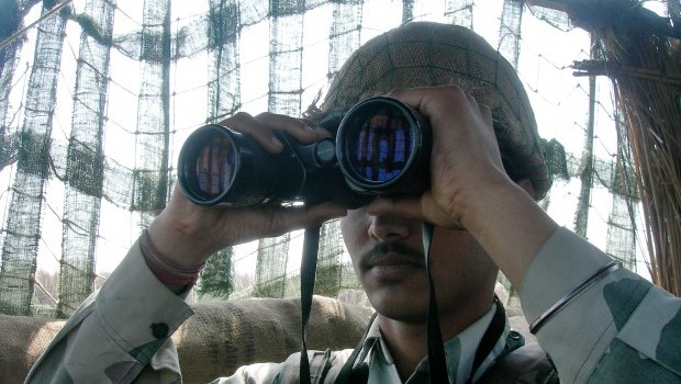 An Indian Border Security Force (BSF) soldier keeps vigil inside an outpost along the India-Pakistan border at R S Pura International Border, 25 kms south of Jammu on August 6, 2013. (AFP Photo/Tauseef Mustafa)