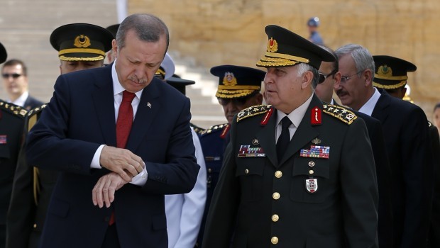 Turkey's Prime Minister Tayyip Erdogan checks his watch as he attends a wreath-laying ceremony with Chief of Staff General Necdet Ozel at the mausoleum of Mustafa Kemal Ataturk, founder of modern Turkey, in Ankara August 1, 2013. (Reuters/Umit Bektas)