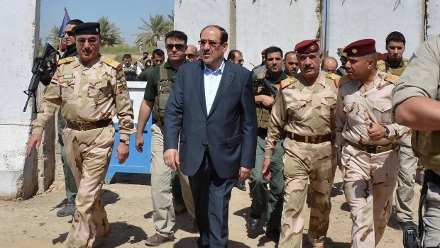 A handout picture released by the Iraqi prime minister's media office shows Iraqi Prime Minister Nuri al-Maliki touring military posts in the outskirts of Baghdad on August 6, 2013. (AFP Photo/Ho/Iraqi Prime Ministers Office)