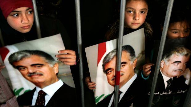 Lebanese girls hold pictures of former Prime Minister Rafik Hariri as they visit his grave in Beirut's Martyrs Square. (Reuters/Damir Sagolj/Files)
