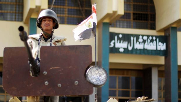An Egyptian soldier keeps watch atop an armored vehicle next to the North Sinai Government building during celebrations on the 40th anniversary of the 1973 Arab-Israeli war in El-Arish, North Sinai, Egypt, 06 October 2013. (EPA)