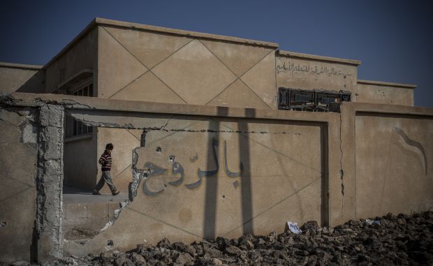 Photo of school wall destroyed in Jabhat Al-Nusra assault on Alouk. (Hannah Lucinda Smith/Asharq Al-Awsat)