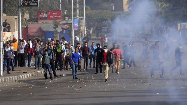 Al-Azhar University student supporters of the Muslim Brotherhood and ousted Egyptian President Mohamed Mursi react as teargas is fired by Egyptian security forces during a clash in front of the main gate of the university in Cairo on December 10, 2013. (REUTERS/Stringer)