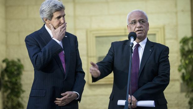 U.S. Secretary of State John Kerry, left, listens to Palestinian negotiator Saeb Erekat make a statement to the press after meeting with Palestinian President Mahmoud Abbas at the presidential compound in the West Bank city of Ramallah on Saturday, Jan. 4, 2014 (AP Photo/Brendan Smialowski, Pool)