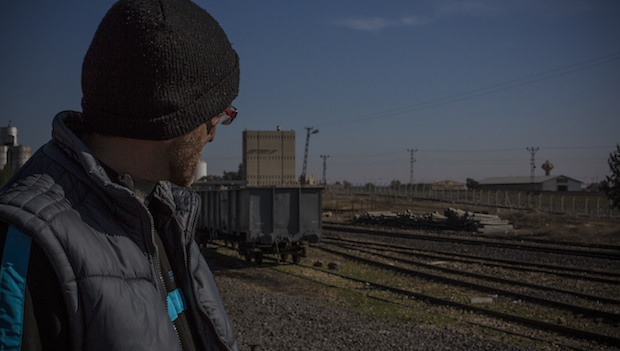 Abu Hussein looks across the border to his house in Tel Abyad, Syria. (Asharq Al-Awsat/Hannah Lucinda Smith)