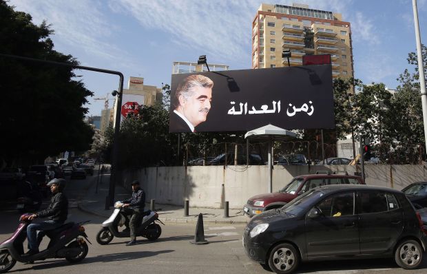 A billboard bearing a portrait of late Lebanese premier Rafik Hariri is displayed with the Arabic slogan "The Era of Justice" on a main road in the Lebanese capital Beirut on January 16, 2014. (AFP/Anwar Amro)