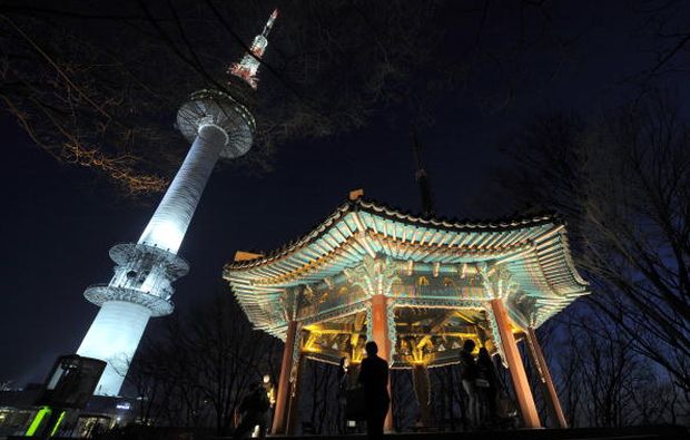 The N Seoul Tower is seen next to a traditional bower on the top of Nam mountain in Seoul on February 22, 2010. The tower was established as a Korea's first total electric wave tower to send TV and radio broadcasts in Seoul metropolitan area in 1969. (AFP PHOTO/JUNG YEON-JE)