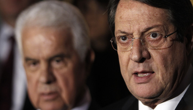 In this Monday, November 25, 2013, file photo, Cyprus's President Nicos Anastasiades (R), and Turkish Cypriot leader Derviş Eroğlu (L), talk to the media after their meeting in the divided capital Nicosia, Cyprus. (AP Photo/Petros Karadjias, File)