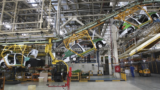 A line of Peugeot 206s on the production line at the Iranian state-run Iran Khodro automobile manufacturing plant near Tehran, Iran, in April 2011. (AP Photo/Vahid Salemi, File)