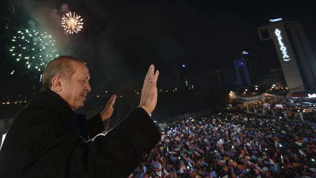 In this photo provided by the Turkish Prime Minister's Office, Turkey's Prime Minister Recep Tayyip Erdoğan salutes supporters from the balcony of his ruling party headquarters in Ankara, Turkey, early Monday, on March 31, 2014. (AP Photo/Kayhan Ozer, Turkish Prime Minister's Press Office)