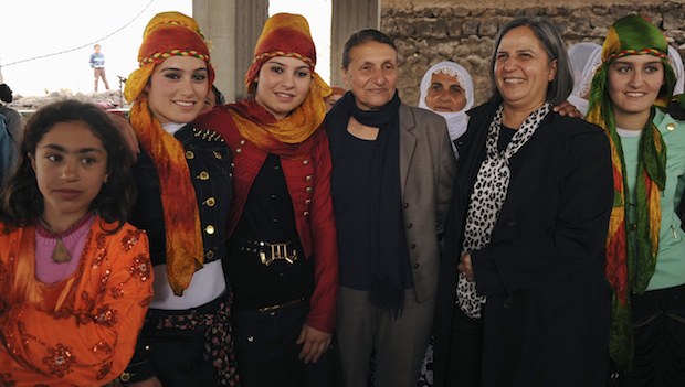 Pro-Kurdish Peace and Democracy Party (BDP) mayoral candidate for Diyarbakır  city Gültan Kışanak (2nd R) and candidate for Bağlar neighborhood Birsen Kaya Akat (4th L) pose with local women during an election campaign in Diyarbakir on February 26, 2014. (REUTERS/Stringer)