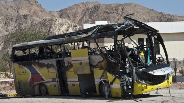 The wreckage of a tour bus that was targeted by a suicide bombing on February 16 is seen in the Egyptian south Sinai resort town of Taba on February 18, 2014. (AFP PHOTO / KHALED DESOUKI)