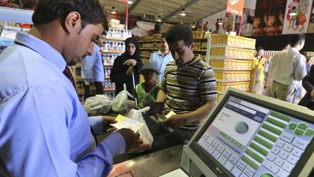 A new Syrian refugee family shops in a market after receiving their humanitarian aid shopping vouchers at the new Azraq Syrian refugee camp near Al-Azraq, east of Amman, on April 30, 2014. (Reuters/Muhammad Hamed)