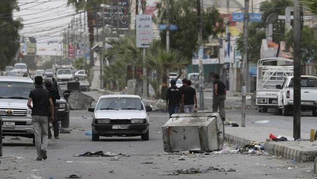 Debris is seen along one of the main streets in Ma’an city, 137 miles (220 kilometers) from Amman, on April 25, 2014, after clashes broke out between local residents and security forces following the funeral of 19-year-old Qusai Al-Emami, who local residents say was killed by security forces, local media reported. (Reuters/Muhammad Hamed)