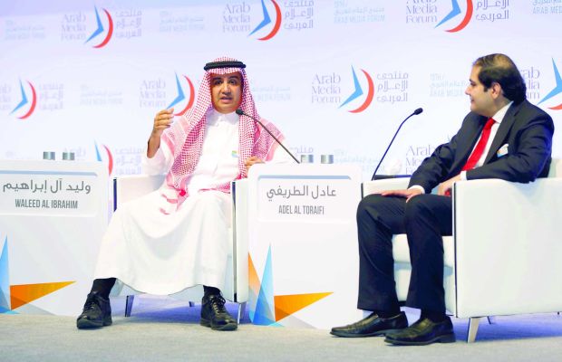 MBC founder and chairman Sheikh Waleed Bin Ibrahim Al Ibrahim (left) speaks to Asharq Al-Awsat Editor-in-Chief Dr. Adel Al-Toraifi at the Dubai Media Forum on May 21, 2014 in Dubai, UAE. (Asharq Al-Awsat)