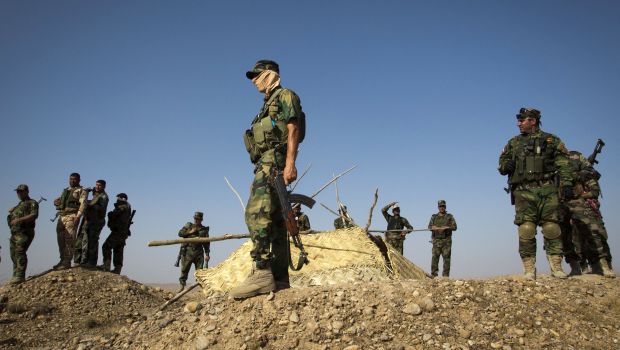 Members of Kurdish Peshmerga forces stand atop a hill during clashes with ISIS militants in Jalawla, Iraq, on June 14, 2014. (AFP Photo/Rick Findler)