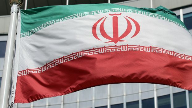 The Iranian flag flies in front of a UN building where closed-door nuclear talks take place at the International Center in Vienna, Austria, on Friday, July 4, 2014. (AP Photo/Ronald Zak)