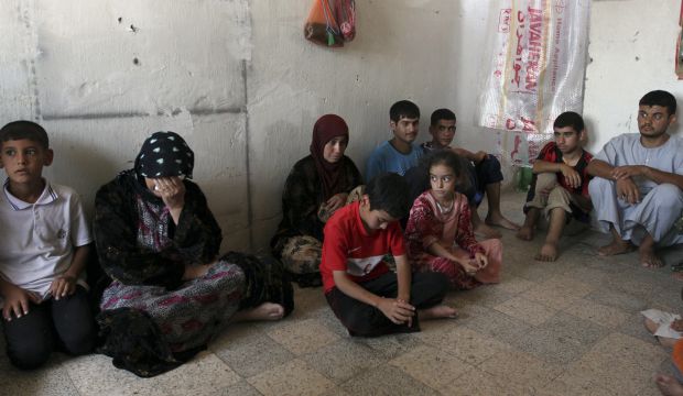 Shi'ite Turkmen families, who have fled the violence in Mosul, gather at a Shi'ite mosque in the town of Nahrawan, east of Baghdad, July 16, 2014. (REUTERS/Mahmoud Raouf Mahmoud)