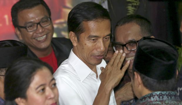 President-elect in Joko Widodo (C) gestures a after press conference in Jakarta, Indonesia, on July 22, 2014. (AP Photo/Tatan Syuflana)