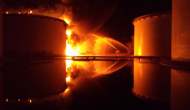 Libyan firefighters dousing a huge blaze at an oil tank started by clashes around Tripoli airport, on July 28, 2014. (AFP Photo/Mohamed Elbosifi)