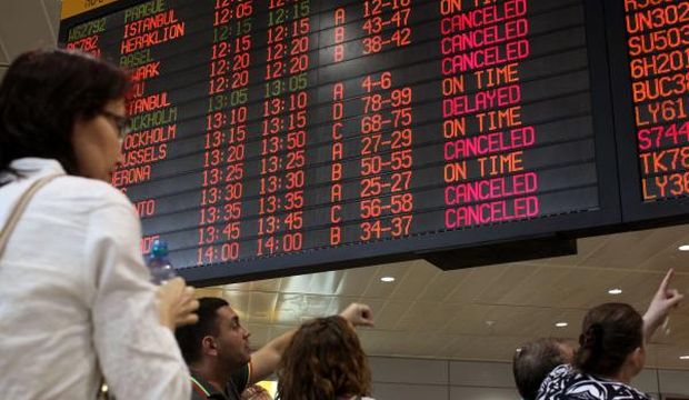 Passengers check a departure time flight board displaying various cancellations at Ben Gurion International airport, near Tel Aviv, Israel, on July 23, 2014. (AFP Photo/Gil Cohen-Magen)