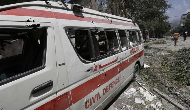 A destroyed Civil Defense ambulance is seen on a street following an Israeli military offensive on the Shejaia neighborhood between Gaza City and the Israeli border on July 20, 2014. (Mohammed Abed/AFP/Getty Images)