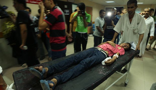 A wounded Palestinian boy, who hospital officials said was injured in an Israeli air strike, is wheeled into a hospital in Gaza City on July 12, 2014. (Reuters/Mohammed Salem)