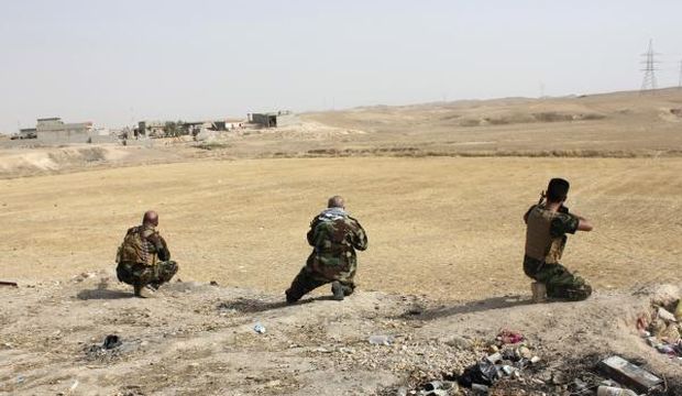Iraqi tribal fighters take their positions to secure an area from militants of the Islamic State of Iraq and Syria in the Hamrin Mountains in Diyala province on July 25, 2014. (Reuters/Stringer)