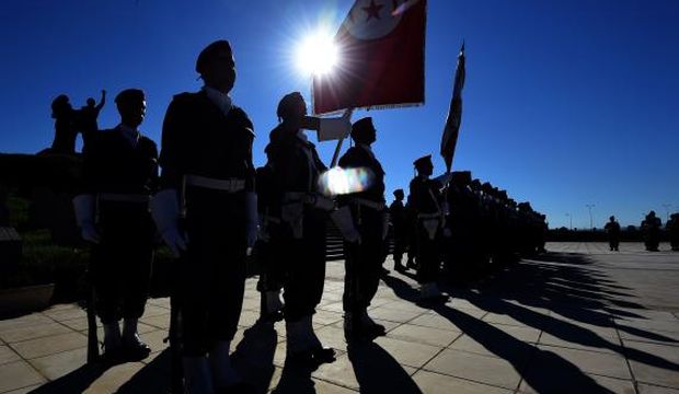 Tunisian military band members perform during a symbolic funeral for soldiers killed by terrorists in the Chaambi Mountains earlier in the week, at the independence martyrs' quarter in the Sejoumi cemetery in the capital Tunis on July 18, 2014. (AFP Photo/Fethi Belaid)