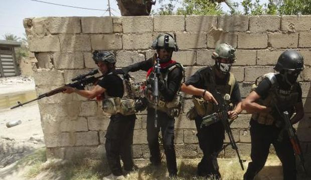 Members of the Iraqi Special Operations Forces patrol looking for militants of the Islamic State of Iraq and Syria in a neighborhood in Ramadi. (Reuters)