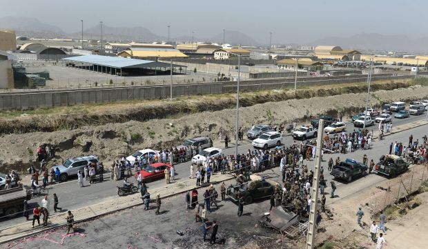 Afghan security forces and locals gather at the site of an attack by the Taliban on Kabul International Airport on July 17, 2014.</br>(AFP Photo/Shah Marai)