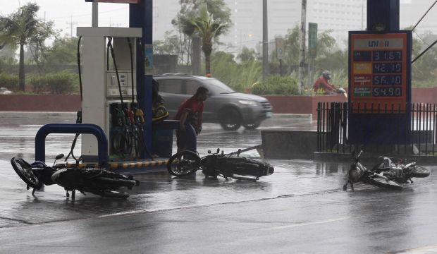 Motorcycles lie along a main road after strong winds brought by Typhoon Rammasun battered the capital Manila on July 16, 2014. (Reuters/Romeo Ranoco)