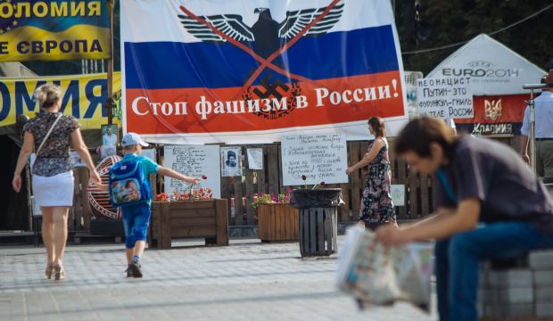 People pass by a banner reading 'Stop fascism in Russia' in Independence Square in Kiev, Ukraine on 17 July, 2014. (EPA/Roman Pilipey)
