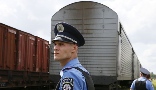A Ukrainian policeman watches as a train carrying the remains of the victims of Malaysia Airlines MH17 arrives in the city of Kharkiv in eastern Ukraine on July 22, 2014. (Reuters/Gleb Garanich)