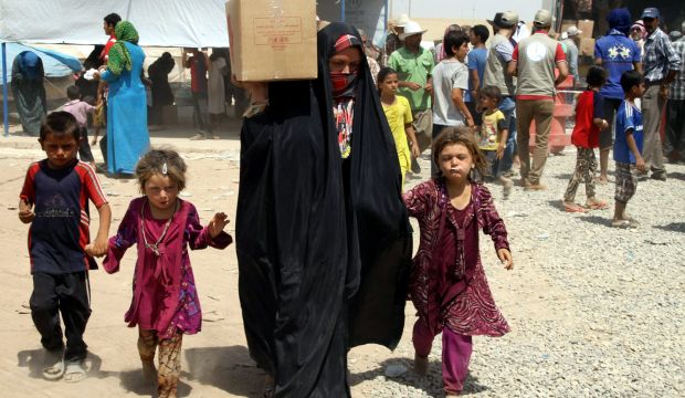 Iraqi families displaced by fighting in their home towns receive humanitarian aid at the Khazir refugee camp, near Erbil, northern Iraq, on July 23, 2014. (EPA/Kamal Akrayi)