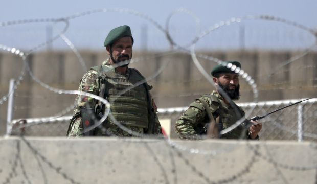 Afghanistan National Army soldiers stand guard at a gate of Camp Qargha, west of  Kabul, Afghanistan, on August 5, 2014. (AP Photo/Massoud Hossaini)