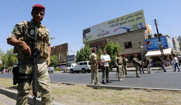 Iraqi security forces patrol a street in Baghdad's commercial district of Karrada on August 11, 2014 as security measures have been reinforced across the capital after Iraq's prime minister said he would sue the president in a desperate bid to cling to his job. (AFP PHOTO/SABAH ARAR)