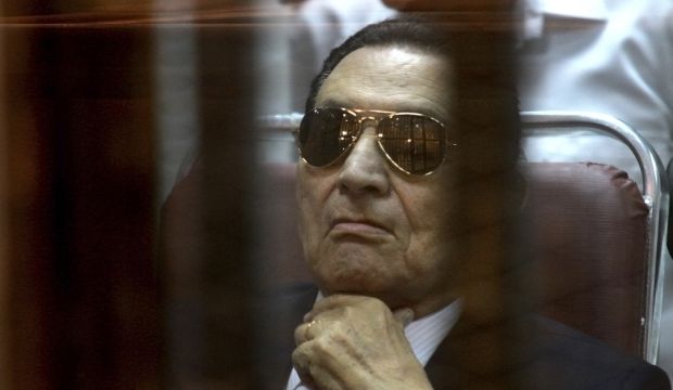 Ousted Egyptian President Hosni Mubarak attends a hearing in his retrial over charges of failing to stop killings of protesters during the 2011 uprising that led to his downfall, in the Police Academy-turned-court in the outskirts of Cairo, Egypt. (AP Photo/Tarek el Gabbas, File)