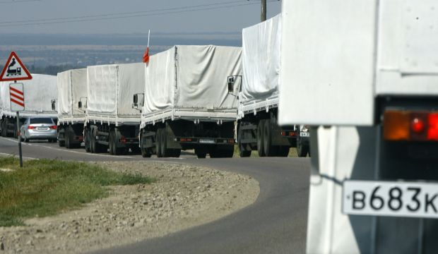 Trucks from a Russian humanitarian convoy arrive outside the town of Kamensk-Shakhtinsky in the Rostov region, some 19 miles (30km) from the Russian-Ukrainian border, Russia, on August 14, 2014. (AFP PHOTO / ANDREY KRONBERG)