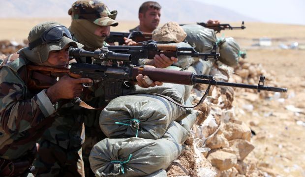 Iraqi Kurdish Peshmerga fighters monitor the area from their front-line position in Bashiqa, a town 8 miles (13 kilometers) north-east of Mosul, Iraq, on August 16, 2014. (AFP Photo/Ahmad Al-Rubaye)