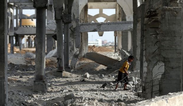 A Palestinian boy makes his way through the rubble of the destroyed and deserted terminal of the Gaza strips former international airport in the southern city of Rafah on August 18, 2014. (AFP PHOTO / THOMAS COEX)