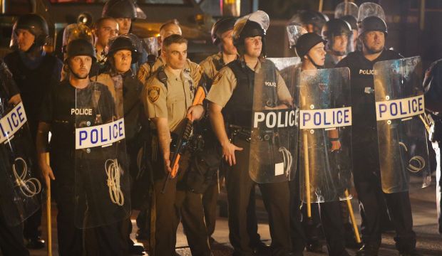 Police watch as demonstrators protest the killing of teenager Michael Brown on August 19, 2014 in Ferguson, Missouri. (Scott Olson/Getty Images/AFP)
