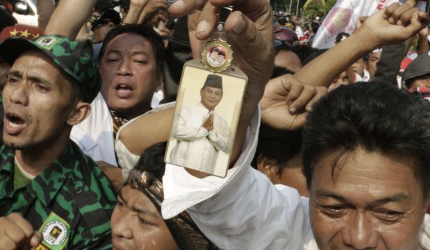 A supporter holds a portrait of losing presidential candidate Prabowo Subianto during a protest near the Constitutional Court in Jakarta, Indonesia, Thursday, August 21, 2014. (AP Photo/Dita Alangkara)