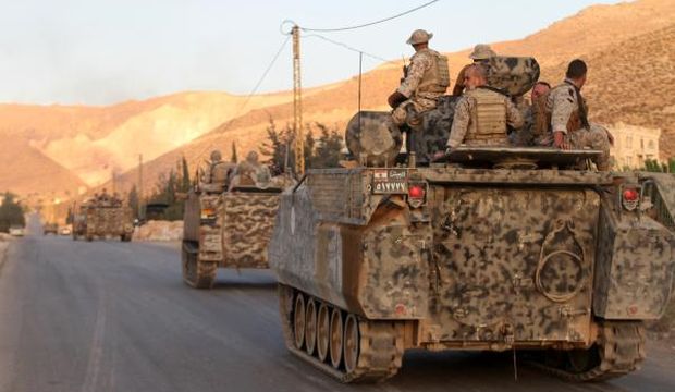 The Lebanese army's armored personal carriers (APC) drive to the entrance of the town of Arsal in the Beqaa Valley by the Syrian border on August 2, 2014. (AFP Photo/STR)