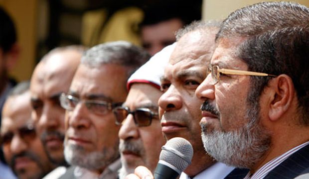 In this April 2011 file photo, Mohamed Mursi (R) speaks, alongside other members of the Muslim Brotherhood group’s political wing, the Freedom and Justice Party (FJP), during a news conference in Cairo, Egypt. (Reuters/Mohamed Abd El Ghany)