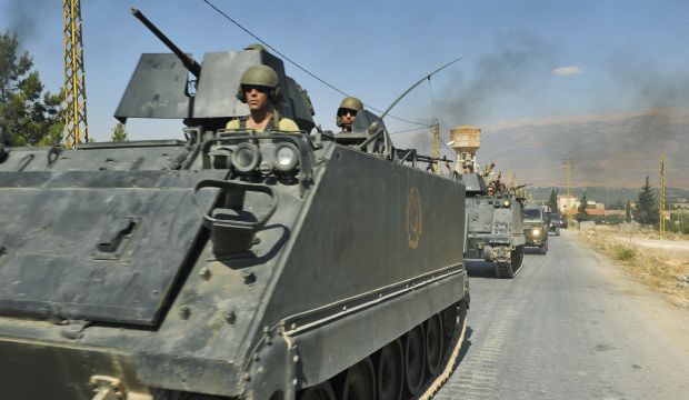 Lebanese army soldiers flash victory signs while riding on armored carriers and military vehicles as they advance towards the Sunni Muslim border town of Arsal, in the eastern Beqaa Valley in Lebanon. (Reuters/Hassan Abdallah)