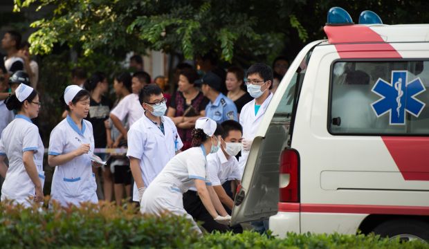 Doctors and nurses rush a victim of the factory explosion for treatment at a hospital in Kunshan on August 2, 2014. (AFP Photo/Johannes Eisele)