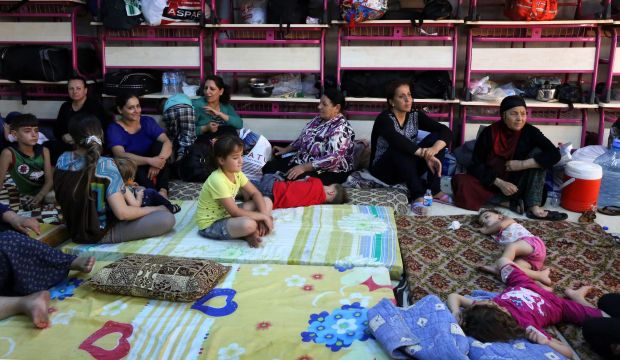Iraqi Christians who fled the violence in the village of Qaraqosh rest upon their arrival at the Saint-Joseph church in the Kurdish city of Erbil, in Iraq's autonomous Kurdistan region, on August 7, 2014. (AFP Photo/Safin Hamed)