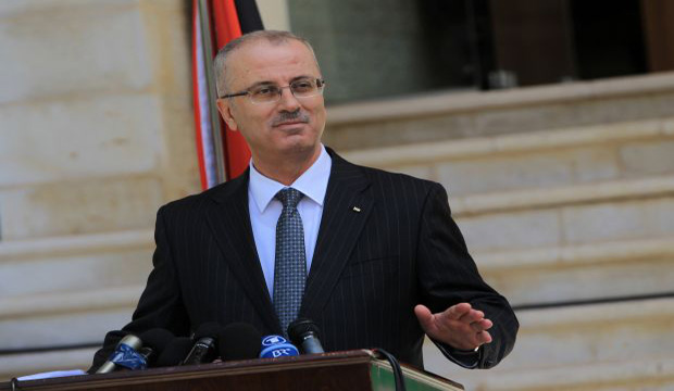 Palestinian Prime Minister Rami Hamdallah speaks during a press conference following the first cabinet meeting of the new Palestinian unity government in the West Bank city of Ramallah on June 3, 2014. (AFP/Abbas Momani)