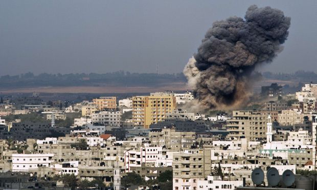 A plume of smoke rises from buildings after an Israeli airstrike in the eastern part of Gaza City on August 22, 2014.  (AFP/Roberto Schmidt)